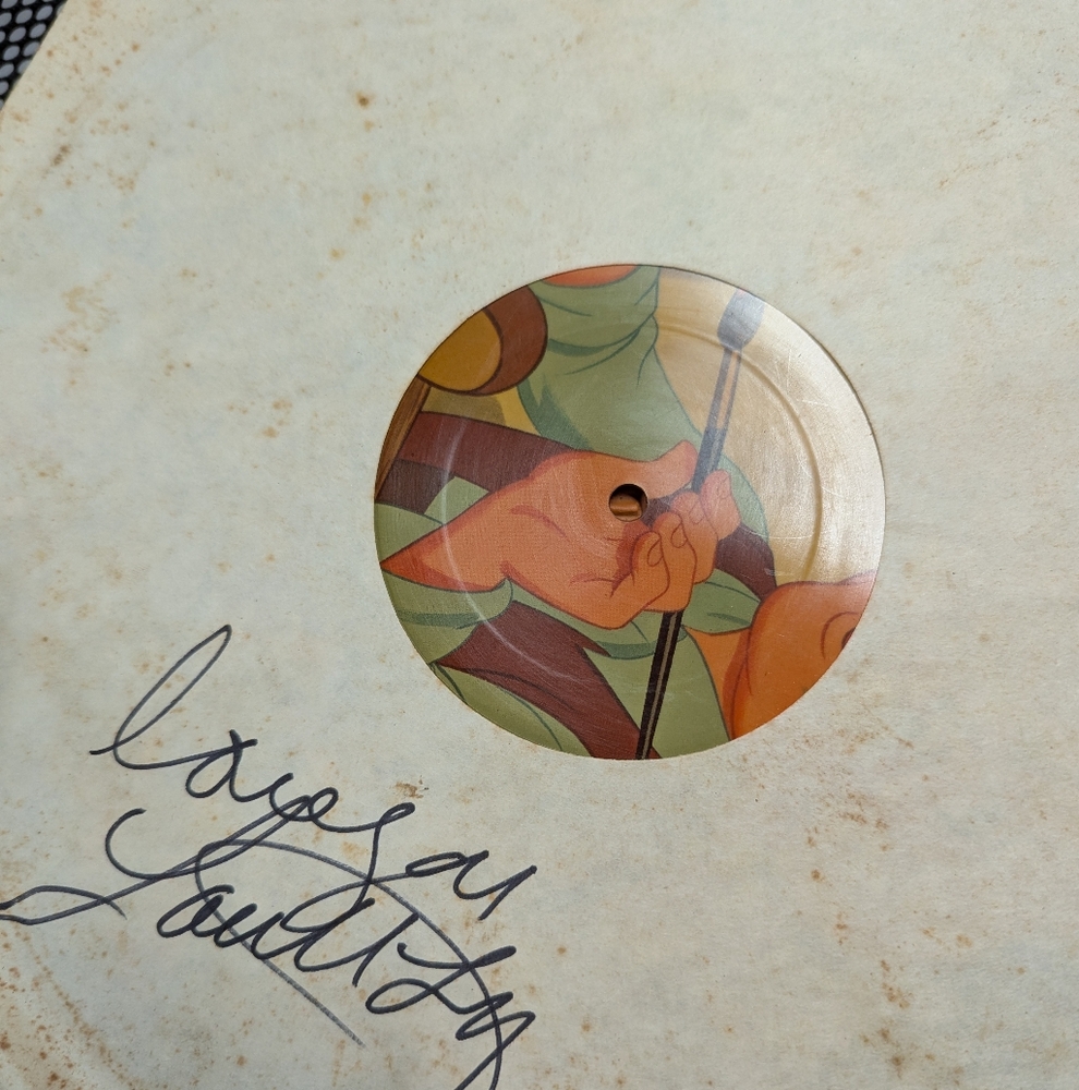 Three Walt Disney vinyl records. Each has a paper liner signed by Loretta Lynn.